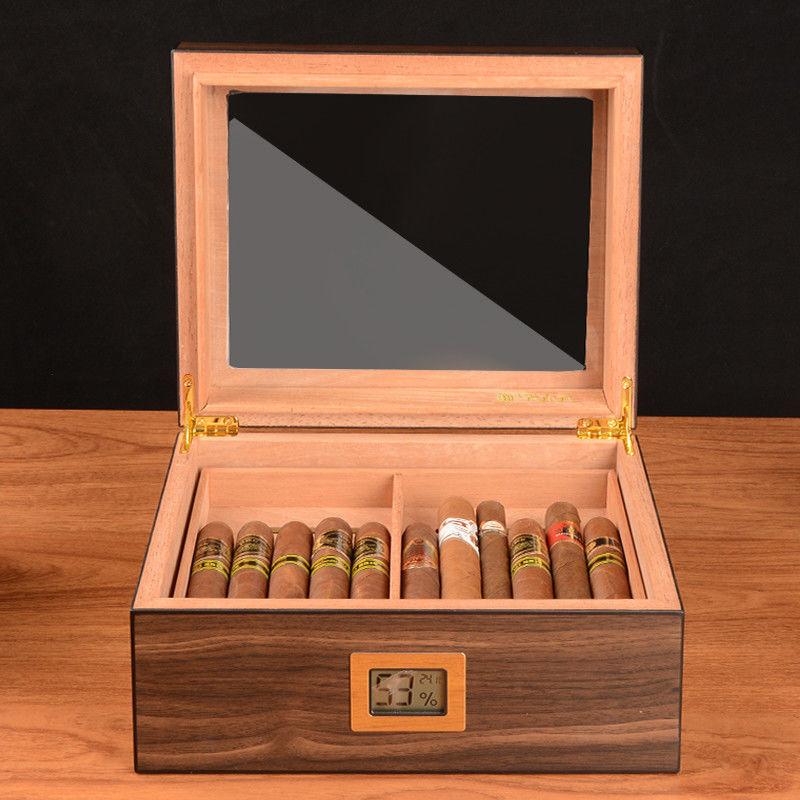 Made from the finest Spanish cedar wood, this humidor features a rich, deep walnut finish that exudes warmth and elegance. The sleek glass top allows for easy viewing of your collection while adding a modern touch.