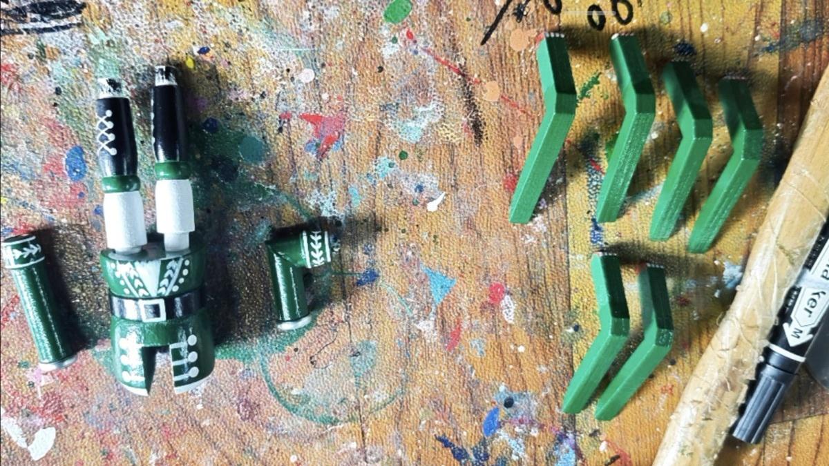 Painted 6-inch nutcracker components undergoing assembly preparation